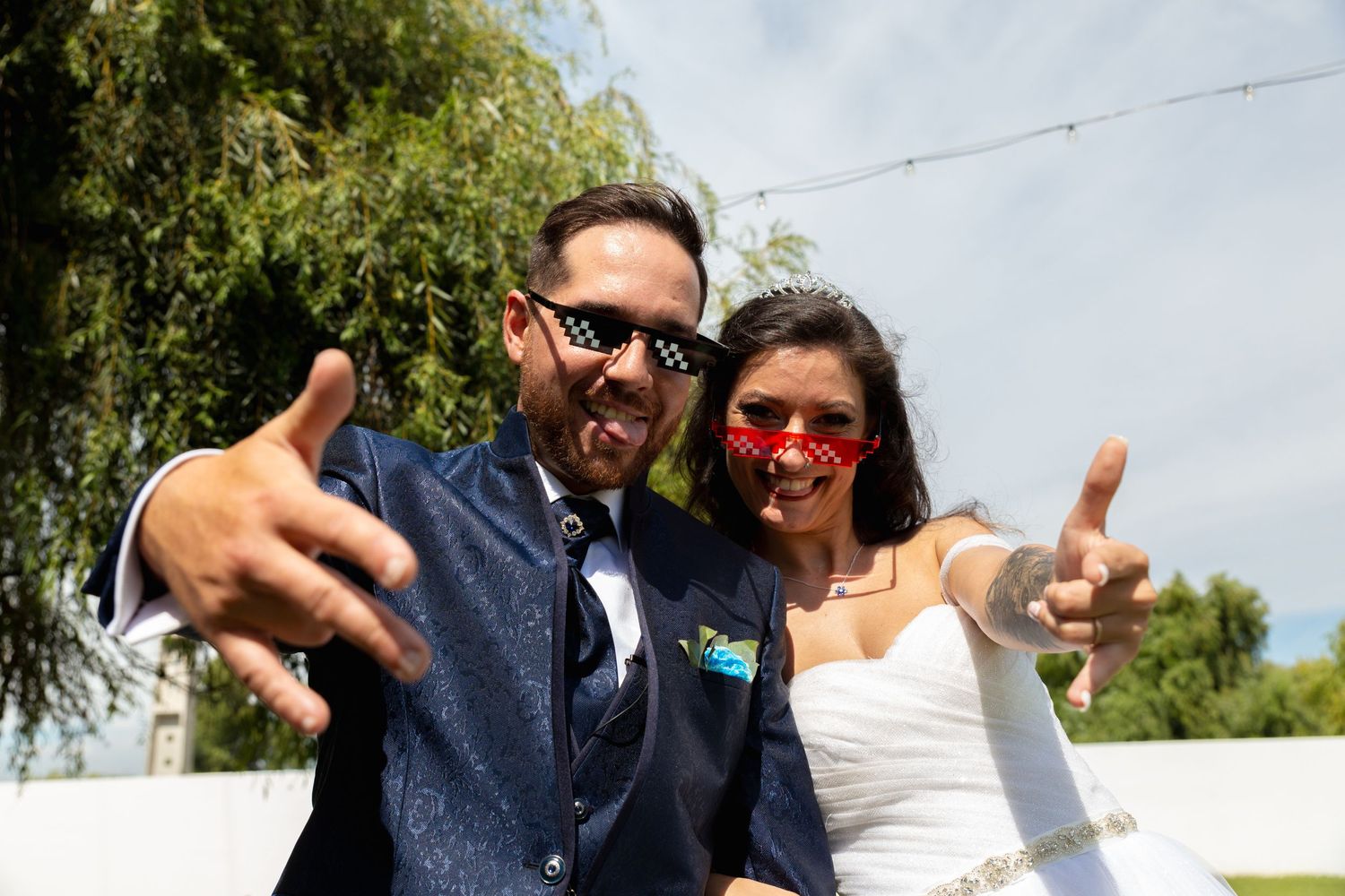Wedding celebration outdoors with guests enjoying festivities under sunny skies.