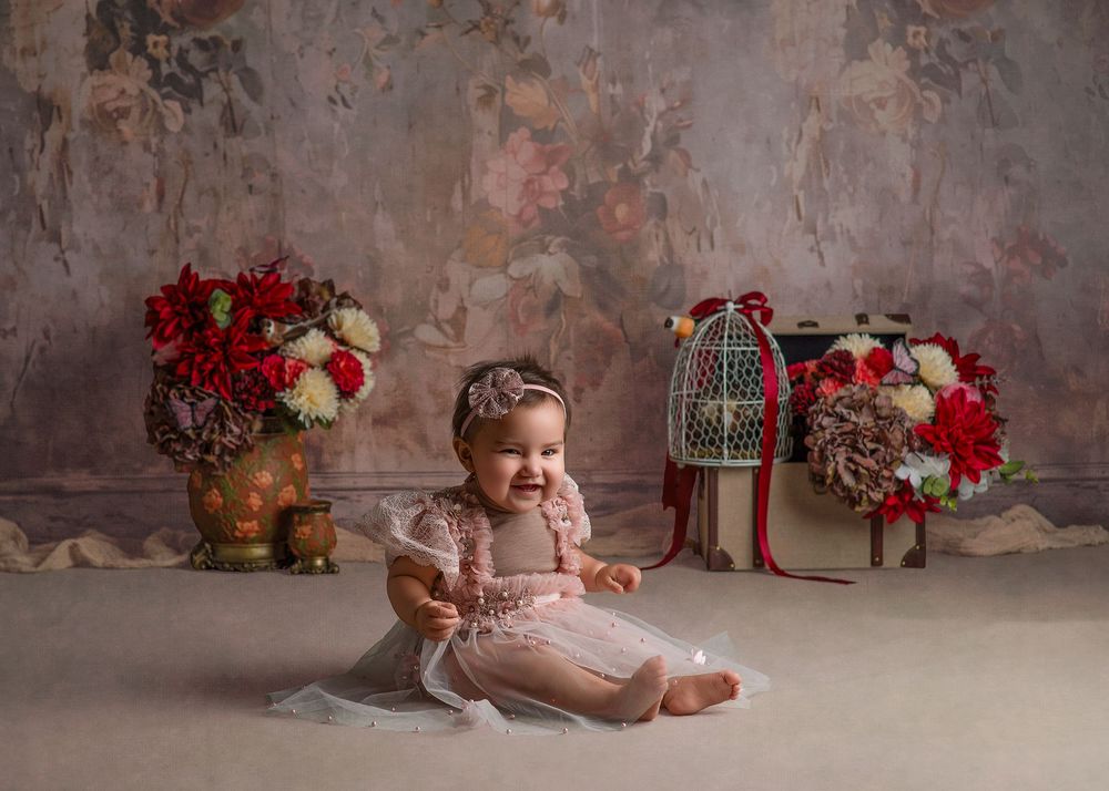 A holiday-themed photo series with presents, vintage decor, and red flowers against a textured gray backdrop.