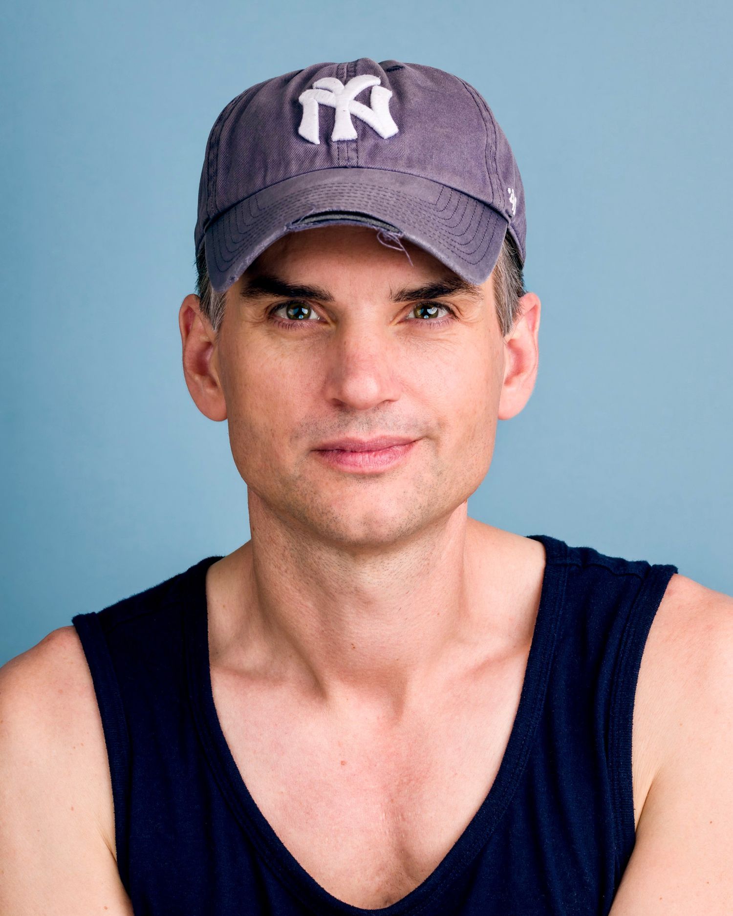 Portrait of Matthew Smedal, photographer and creative behind Postmodern Lightbox, captured with soft light and a signature blue backdrop.