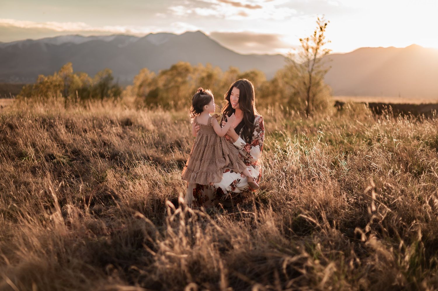 Sunset landscape photography session with mountains and golden light in rustic outdoor setting.