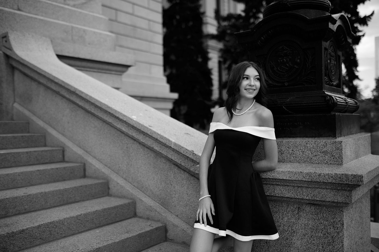 Happy people pose together for wedding photos on stone steps.