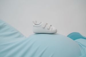 A soft blue and white bedding set with a comforter and pillows arranged on a bed.