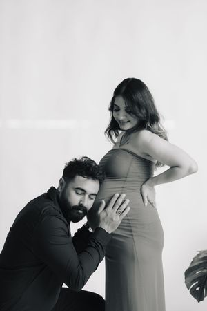 A sweet maternity photo sequence shows intimate moments between an expectant couple in black and white.