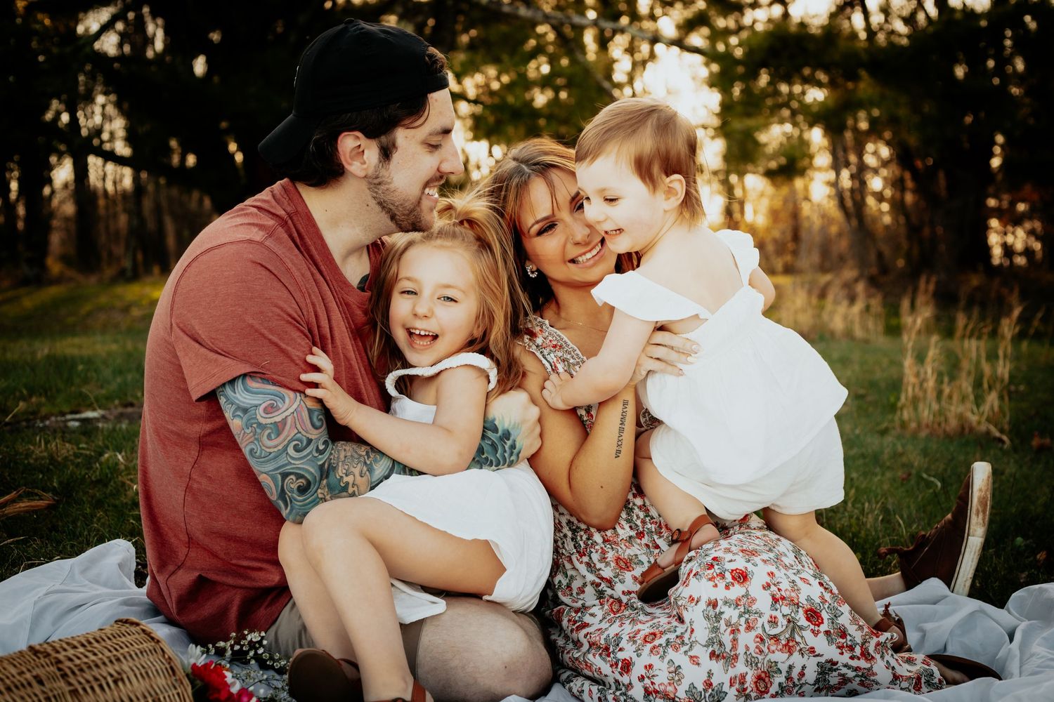 The Rhodes Family laughing and sitting in the grass on the Blue Ridge Parkway.