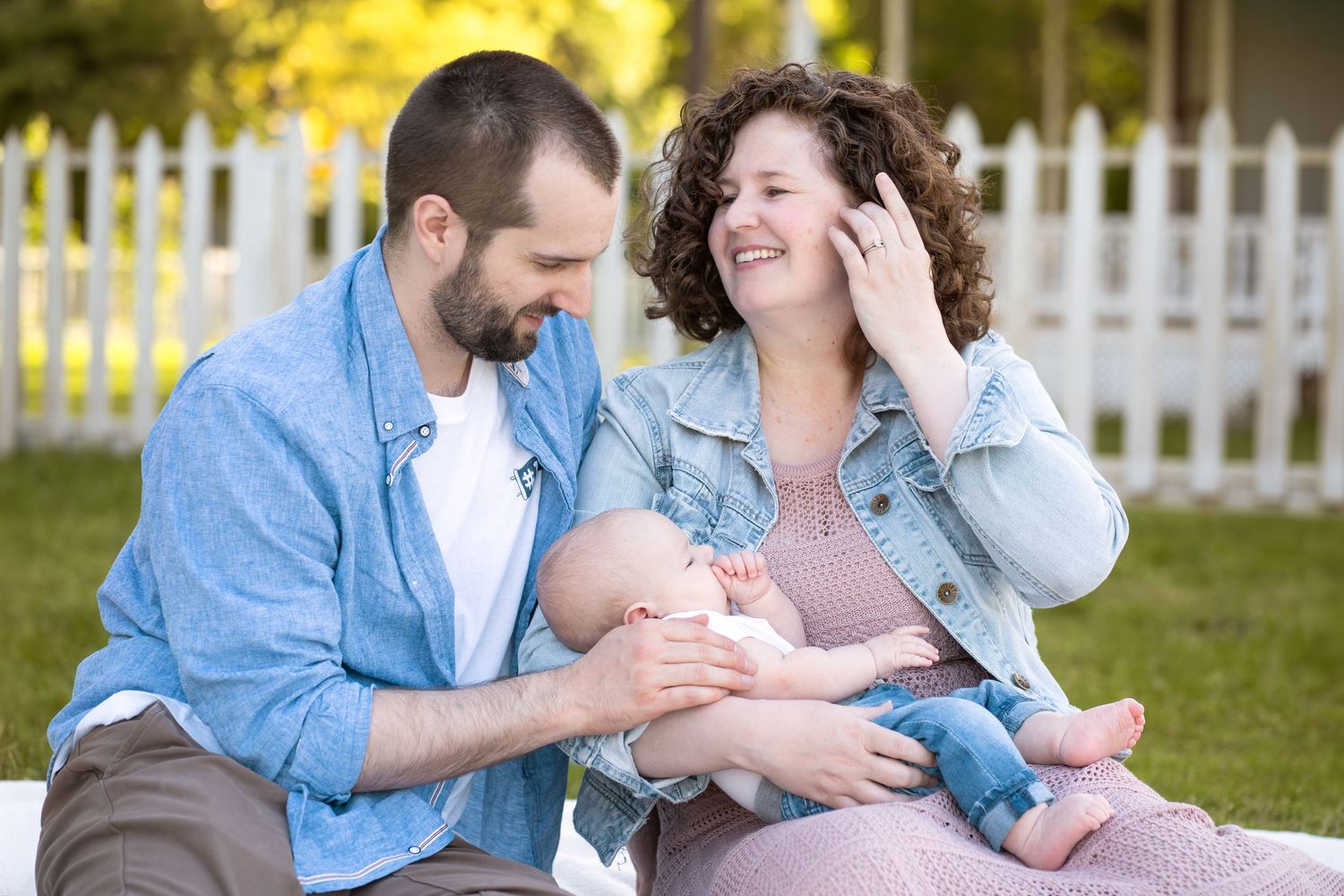 Family portrait series showing parents and child in coordinated neutral outfits.