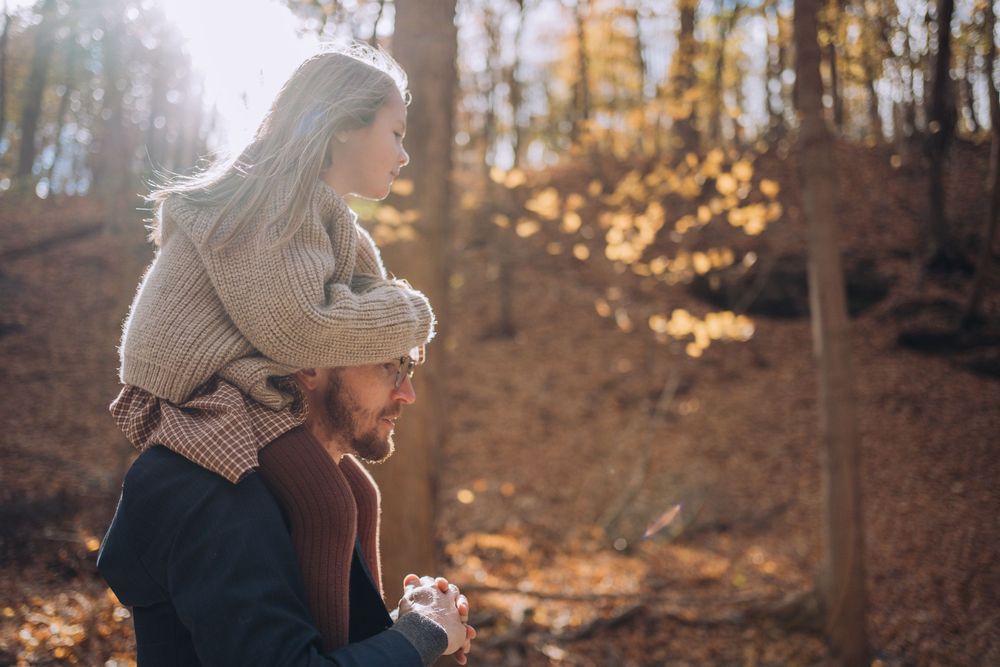 A young girl rides on her dad's shoulders. Shannon Konek, Pittsburgh Photographer