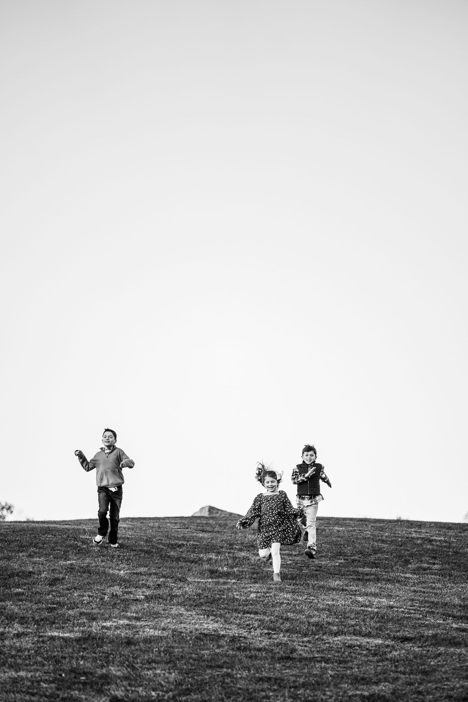Three siblings run down a hill. Shannon Konek, Pittsburgh Photographer