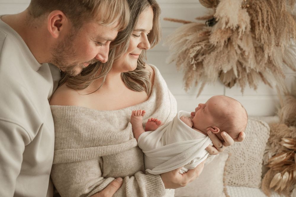 A series of intimate family moments captured in soft beige tones showing tender interactions between loved ones.