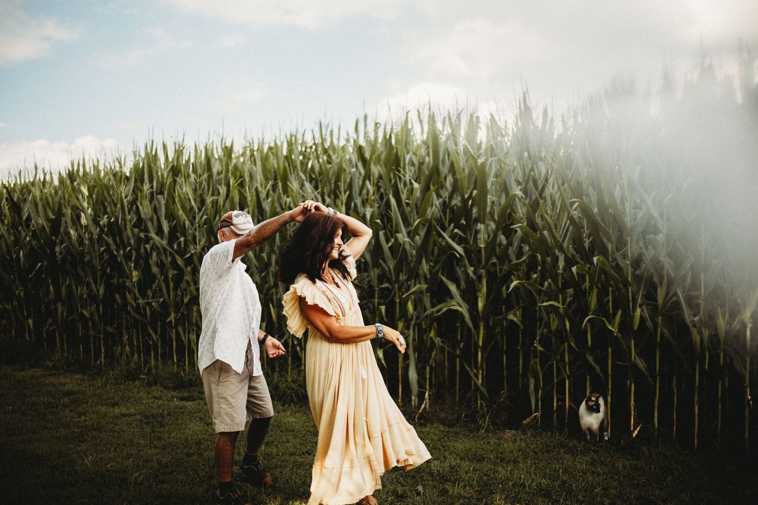 Couple dancing next to a corn field