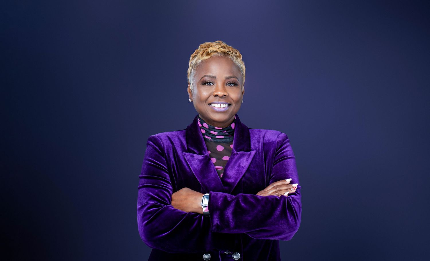 Studio portraits showing performer in purple velvet jacket against dark backdrop.