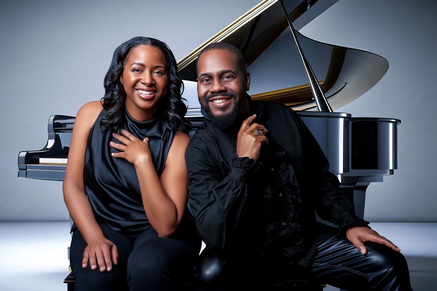 Artistic portraits of couple posing with grand piano in studio setting.