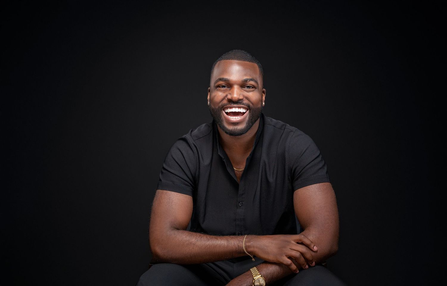 Professional headshots against black background showing warm smiles and casual black attire.