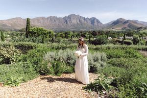 Bride and groom portraits at La Cotte in Franschhoek with mountain views