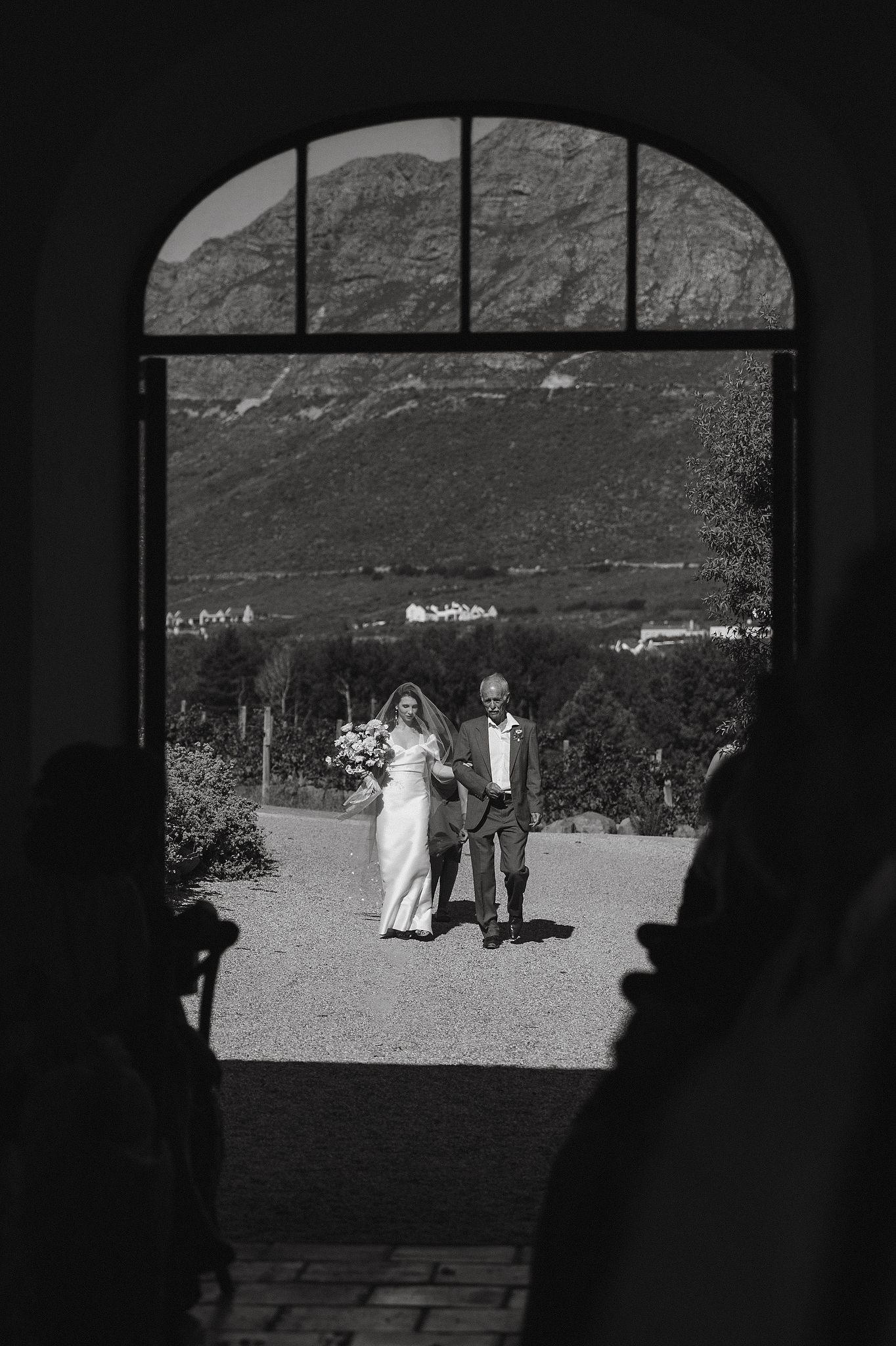 Bride walking down the aisle at La Cotte, Franschhoek with mountain views