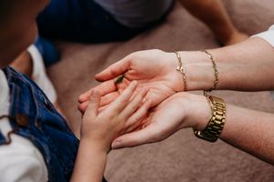 Close-up of hands holding each other in a sequence showing support and connection from different angles.