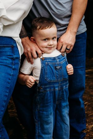 Close-up shots showing coordinated denim and casual wear during an intimate family photoshoot.