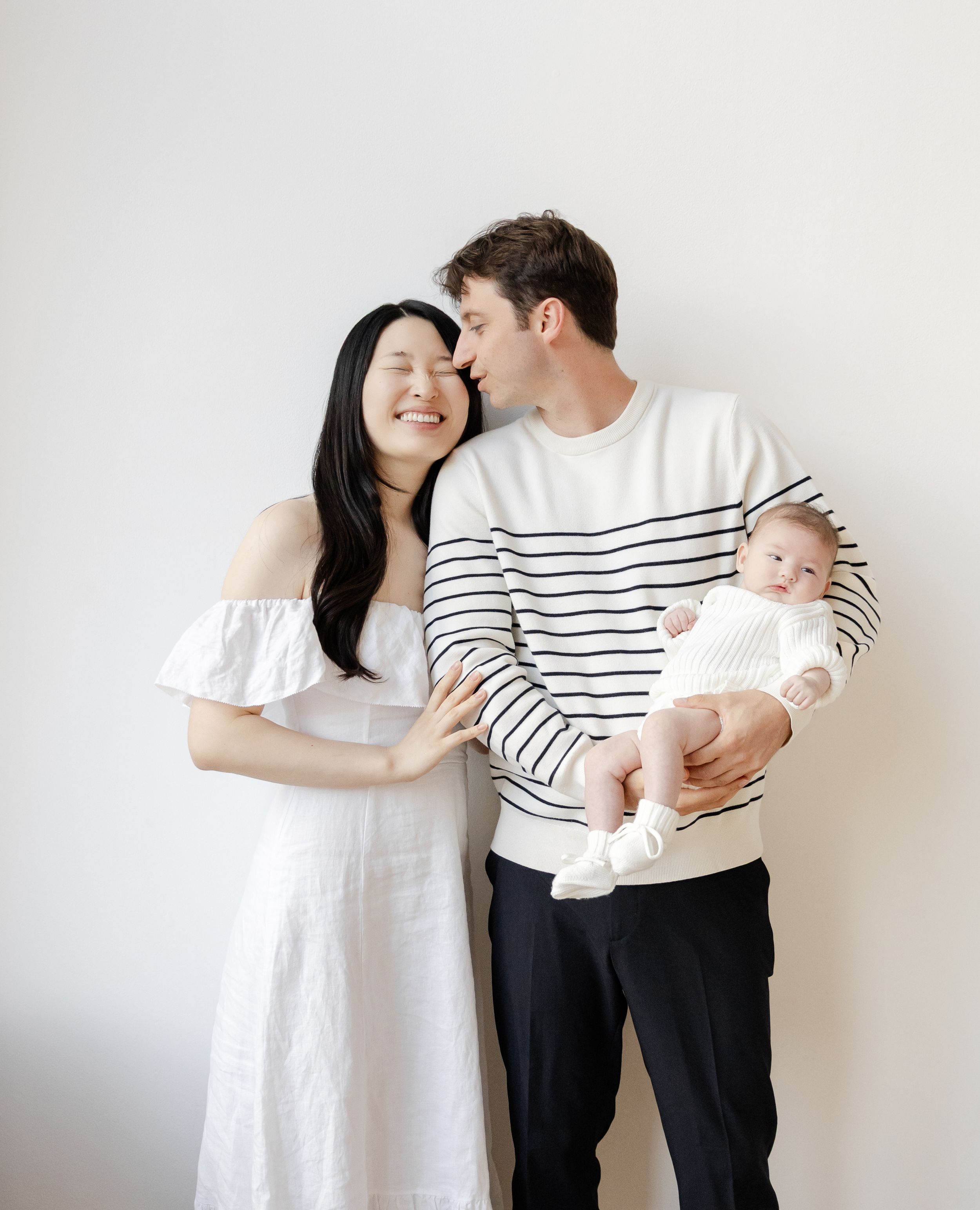 A sweet progression of family photos showing a couple in striped shirts holding and bonding with their newborn baby.