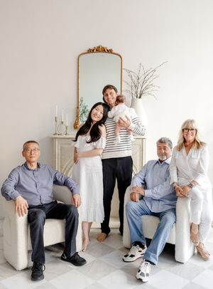 Portrait session with subjects in casual outfits against minimal white background showing affectionate poses and moments.