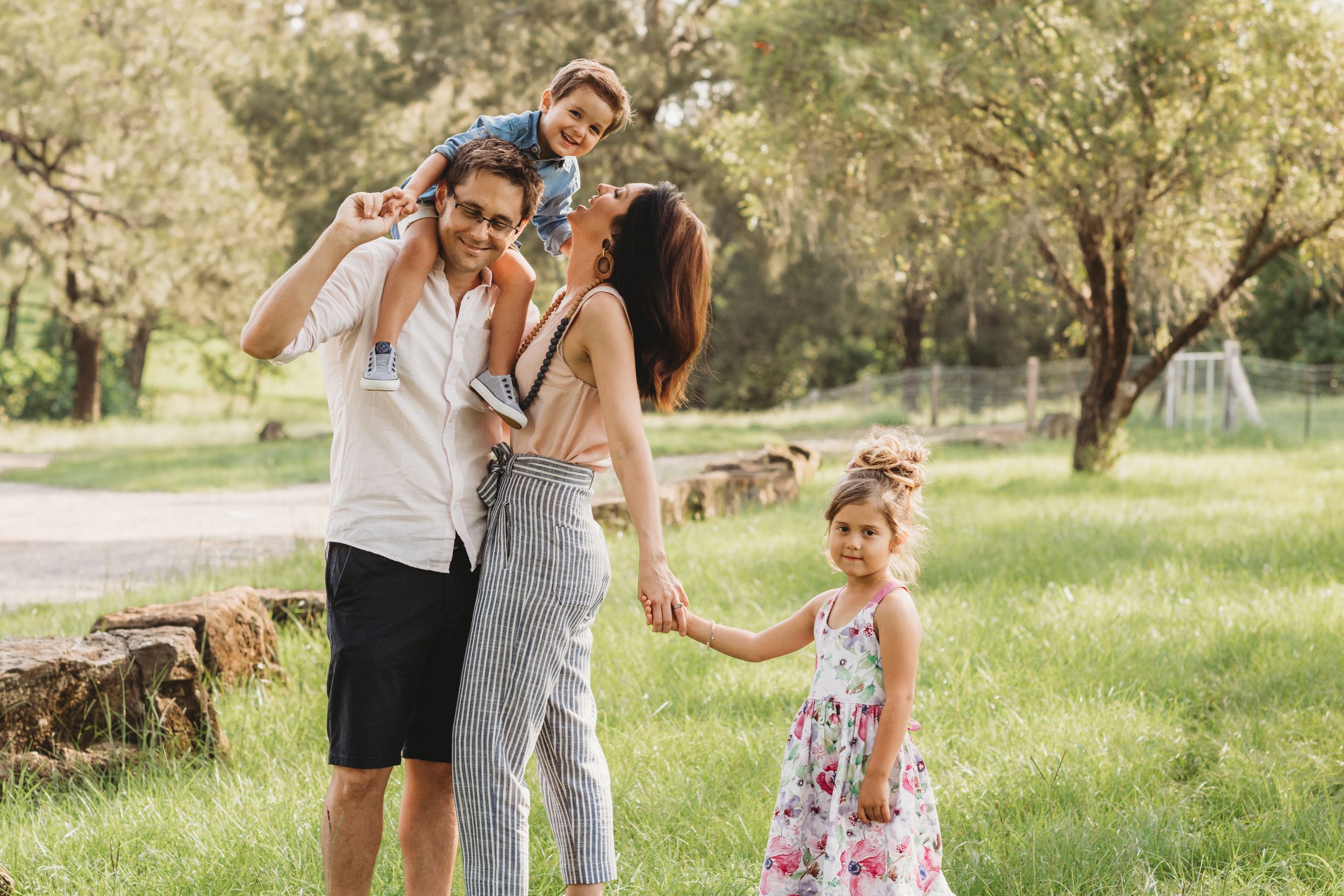 Happy family spending time together in a sunny park on a beautiful day.