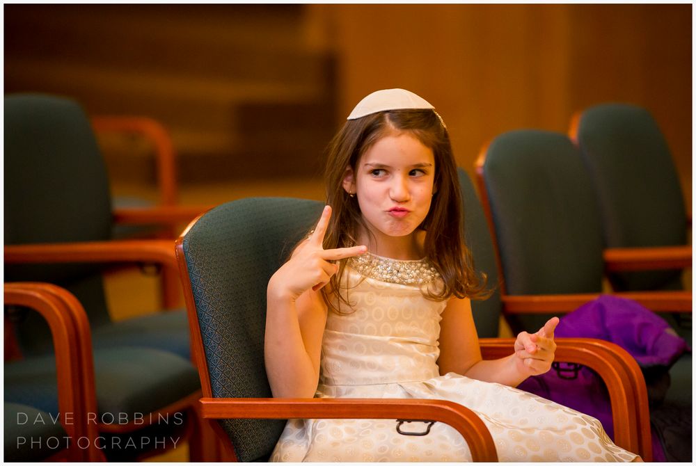Wedding party members seated on modern benches in a reception venue.
