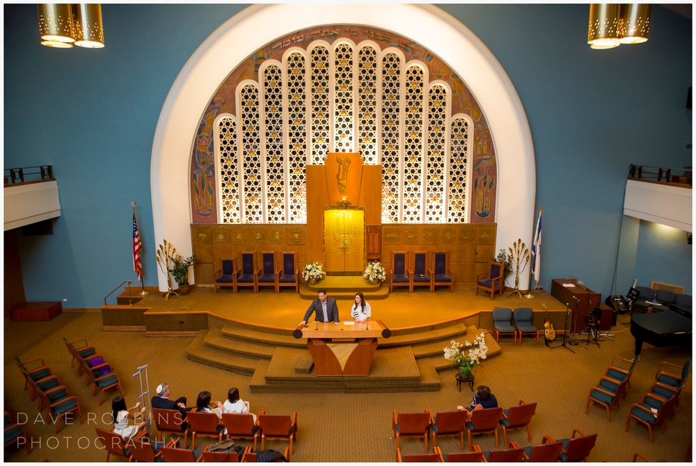 Church sanctuary interior with arched altar area and decorative window screens.