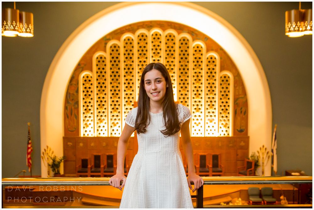 Series of golden-lit archways with ornate lattice patterns in an elegant interior space.