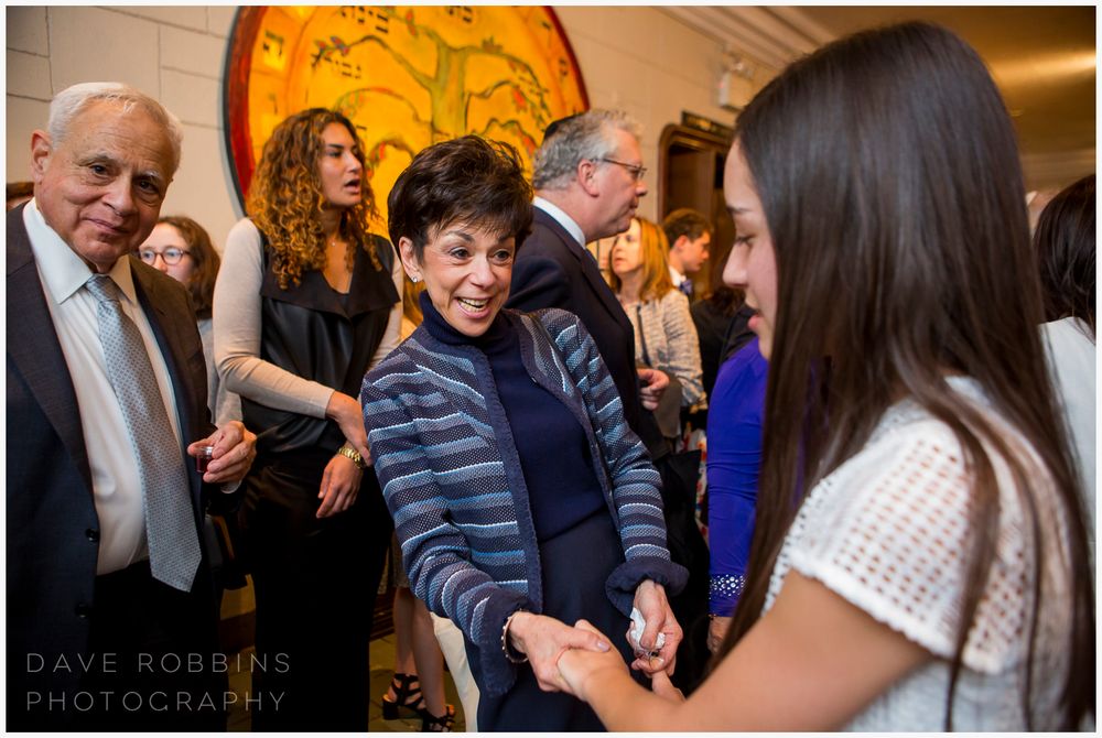 Reception event with warm lighting and people mingling in an indoor venue.