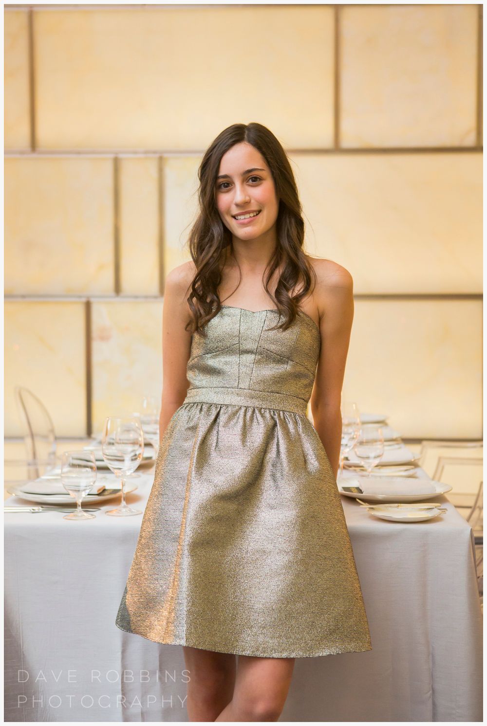 A sequence showing a silver metallic dress twirling against an elegant cream-colored dining room setting.