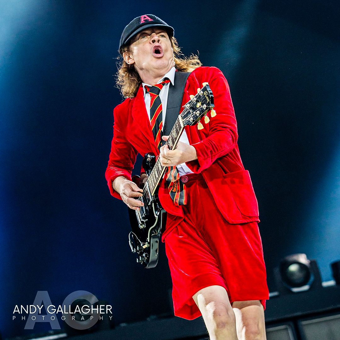 Live music photograph of AC/DC on stage with powerful lighting and rock concert atmosphere captured by Andy Gallagher