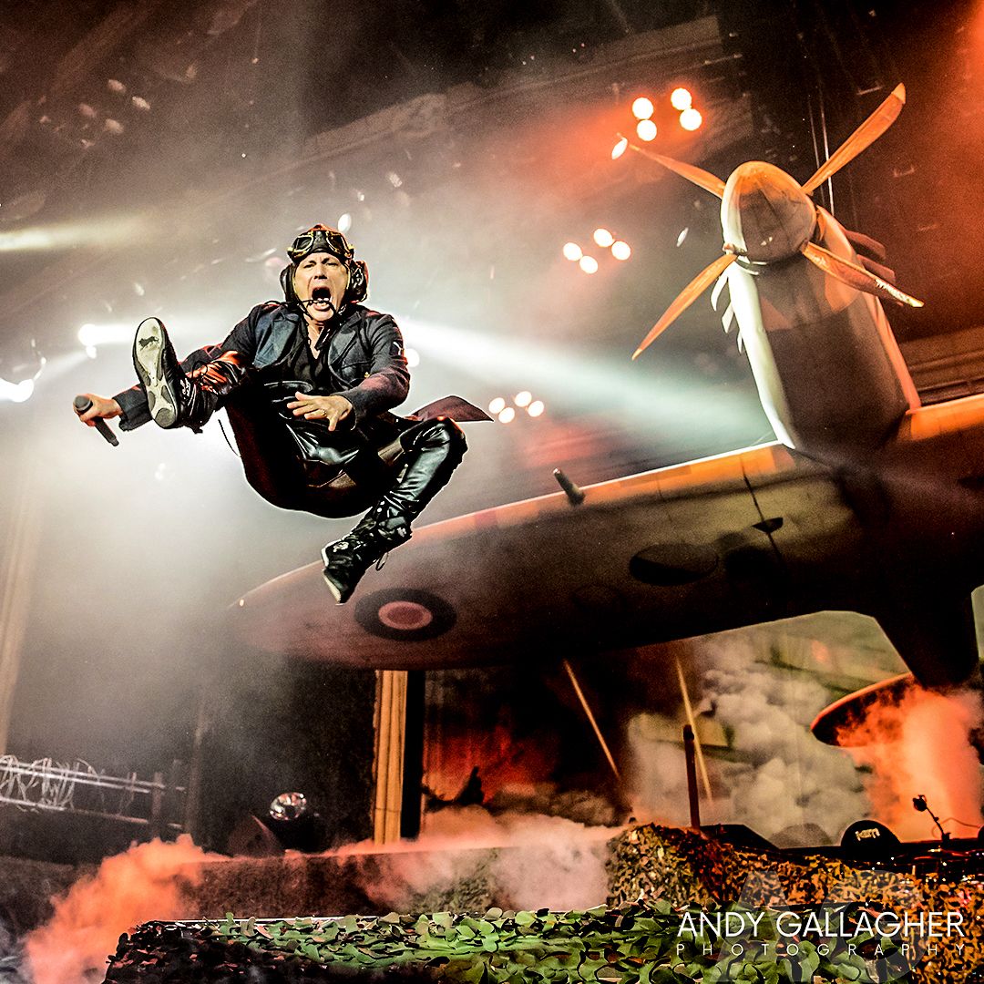 Live music photograph of Iron Maiden on stage with dramatic backdrop and crowd energy captured by Andy Gallagher