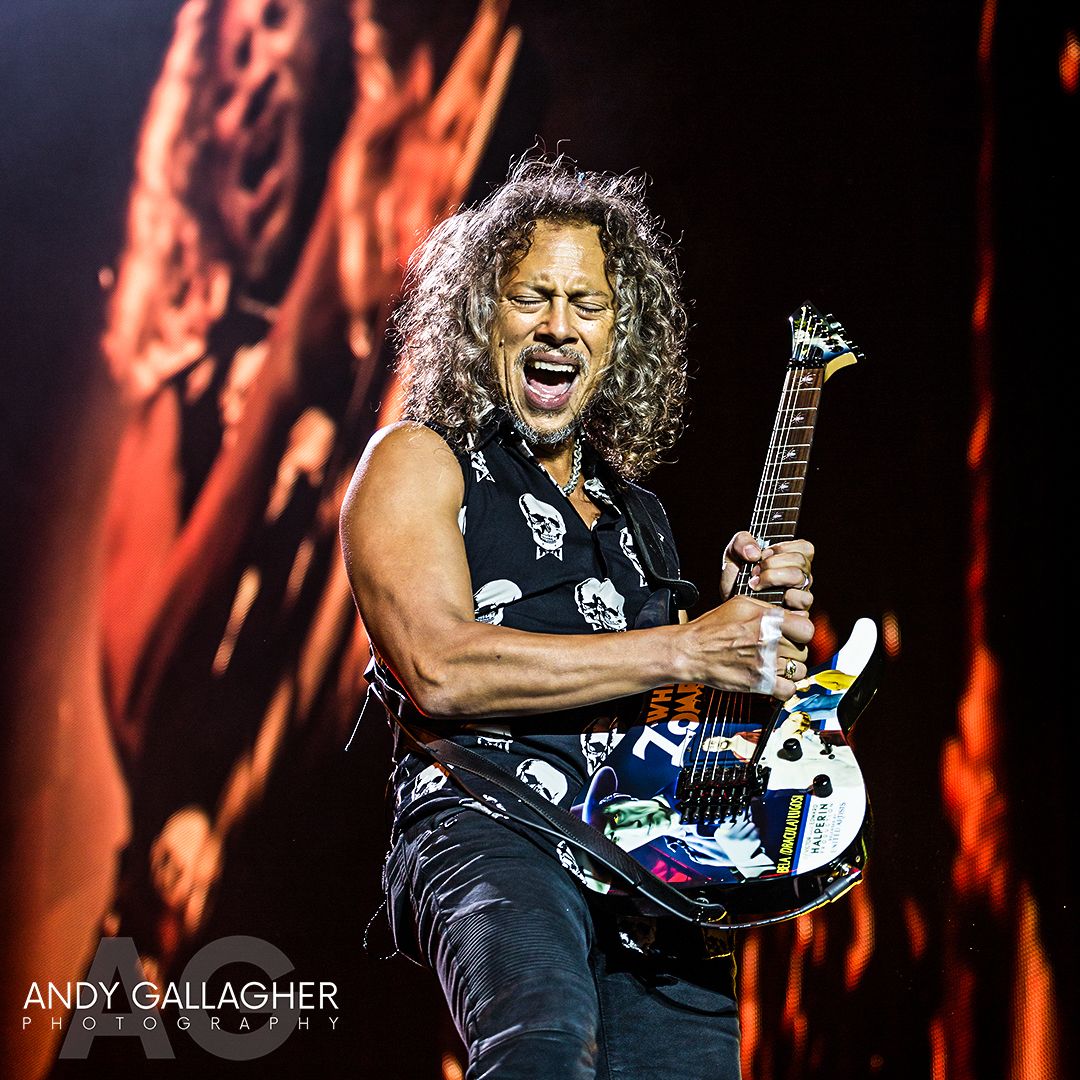 Live music photograph of Metallica performing under dramatic stage lights with crowd energy captured by Andy Gallagher