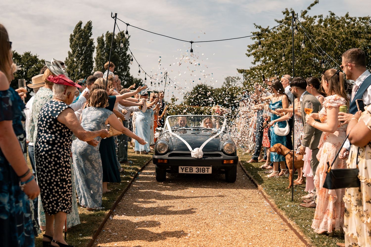 SUFFOLK WEDDING PHOTOGRAPHY - MARQUEE GARDEN WEDDING SUFFOLK - EDITORIAL WEDDING PHOTOGRAPHY VINTAGE CAR CONFETTI SHOT
