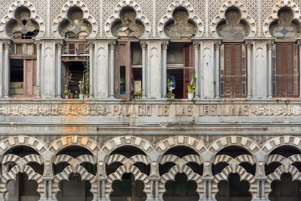 Ornate Gothic architecture of the Grand Place in Brussels featuring detailed stone carvings and arched windows.