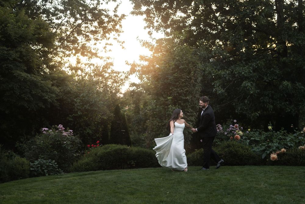 Sunset wedding photography session in a lush garden setting with golden hour lighting.