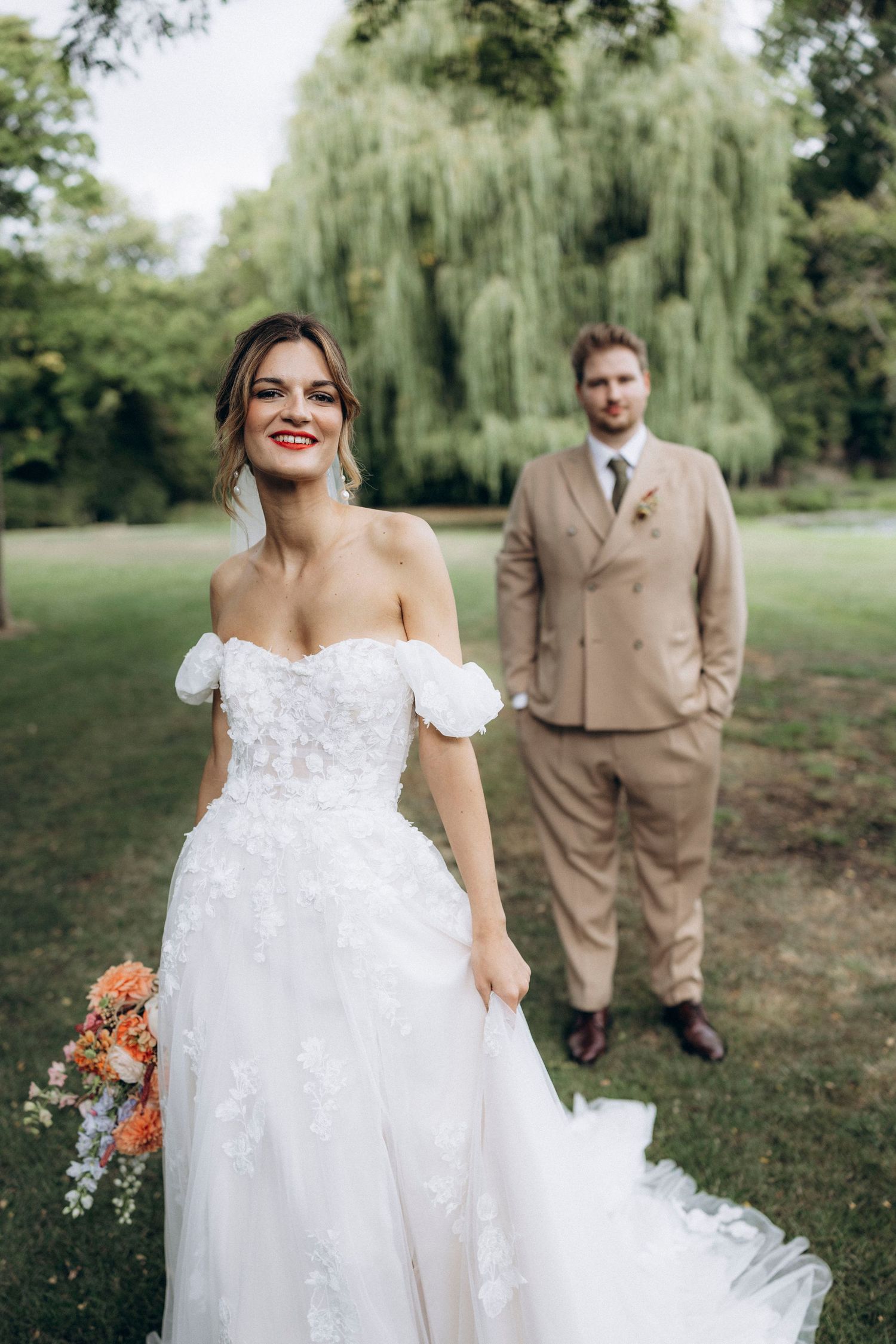 A tender autumn embrace captured during a wedding photoshoot with fall foliage.