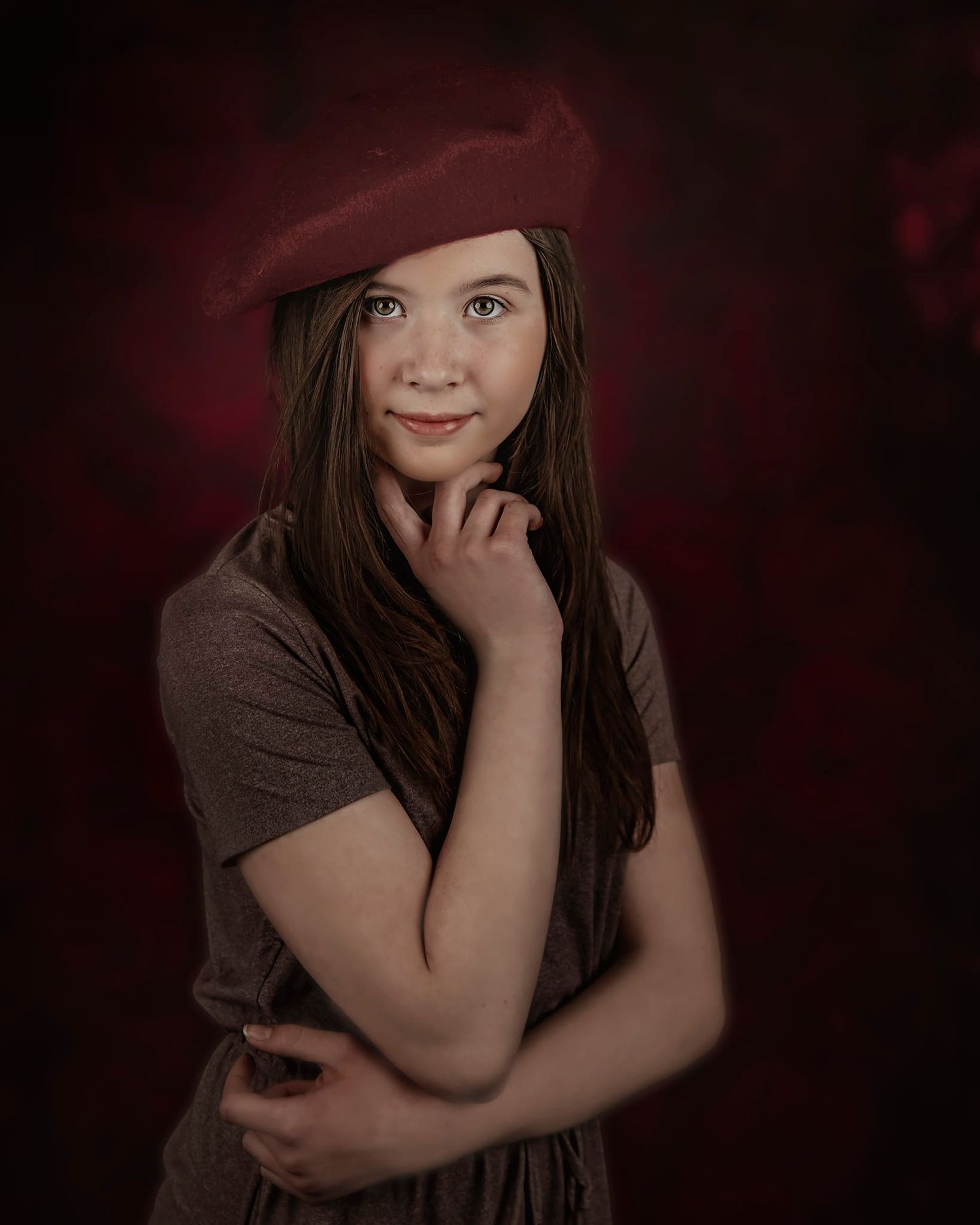 Artistic portrait photography with moody red and dark tones featuring contemplative poses.