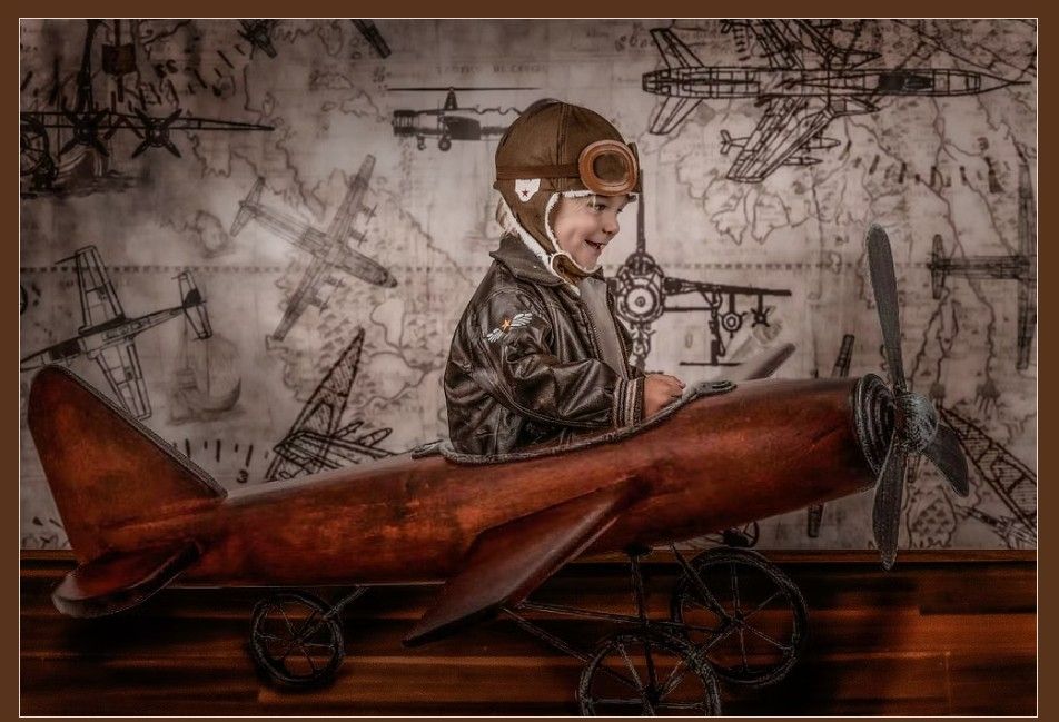 A nostalgic antique wooden airplane toy with a young aviator against a sepia-toned background with maps and diagrams.