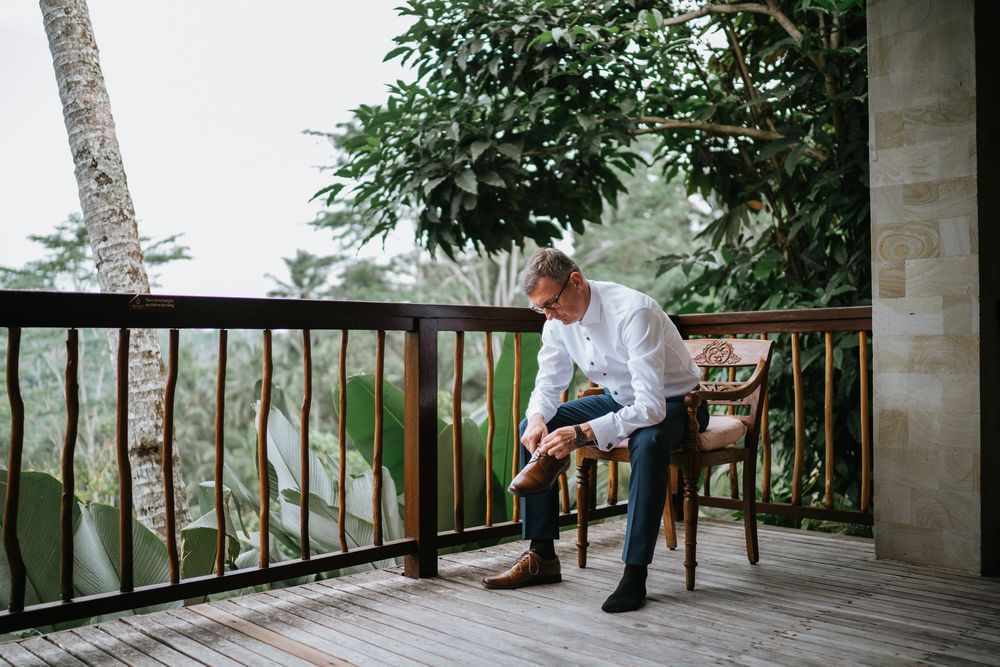 A serene outdoor wedding venue with wooden deck and tropical garden views.