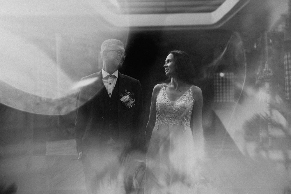 Black and white artistic wedding photography with dreamy, ethereal lighting effects.