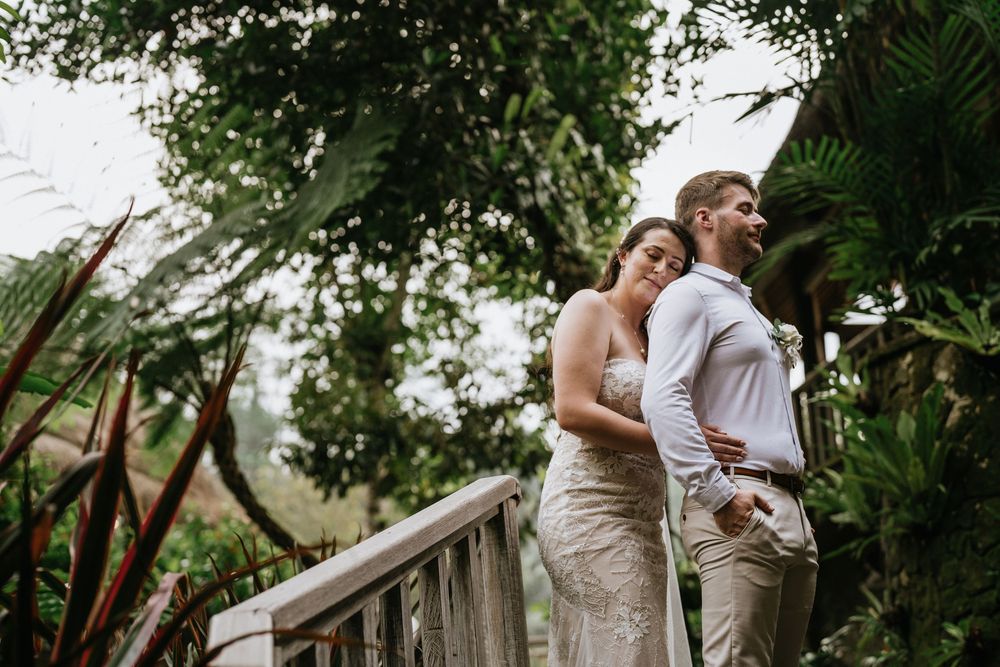 Newlyweds celebrating their special moment on a rustic wooden deck surrounded by nature.