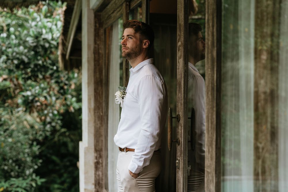 An elegant stone colonnade provides a dramatic backdrop for wedding portraits.