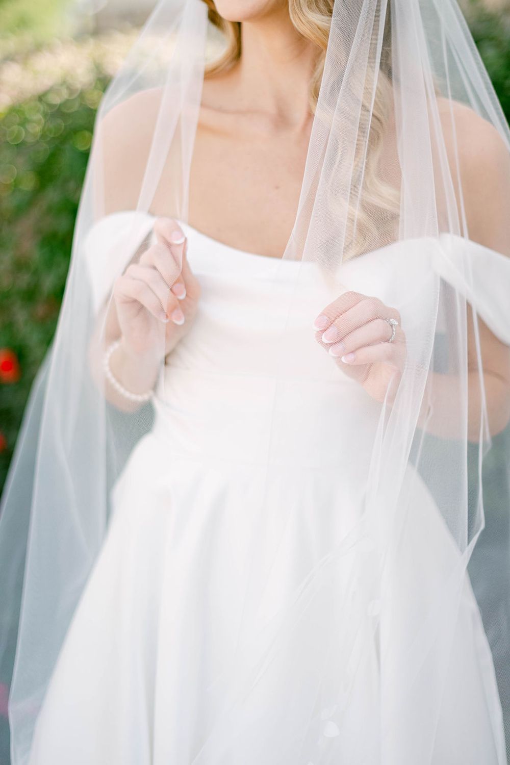 Close-up details of a delicate white wedding veil with soft tulle fabric.