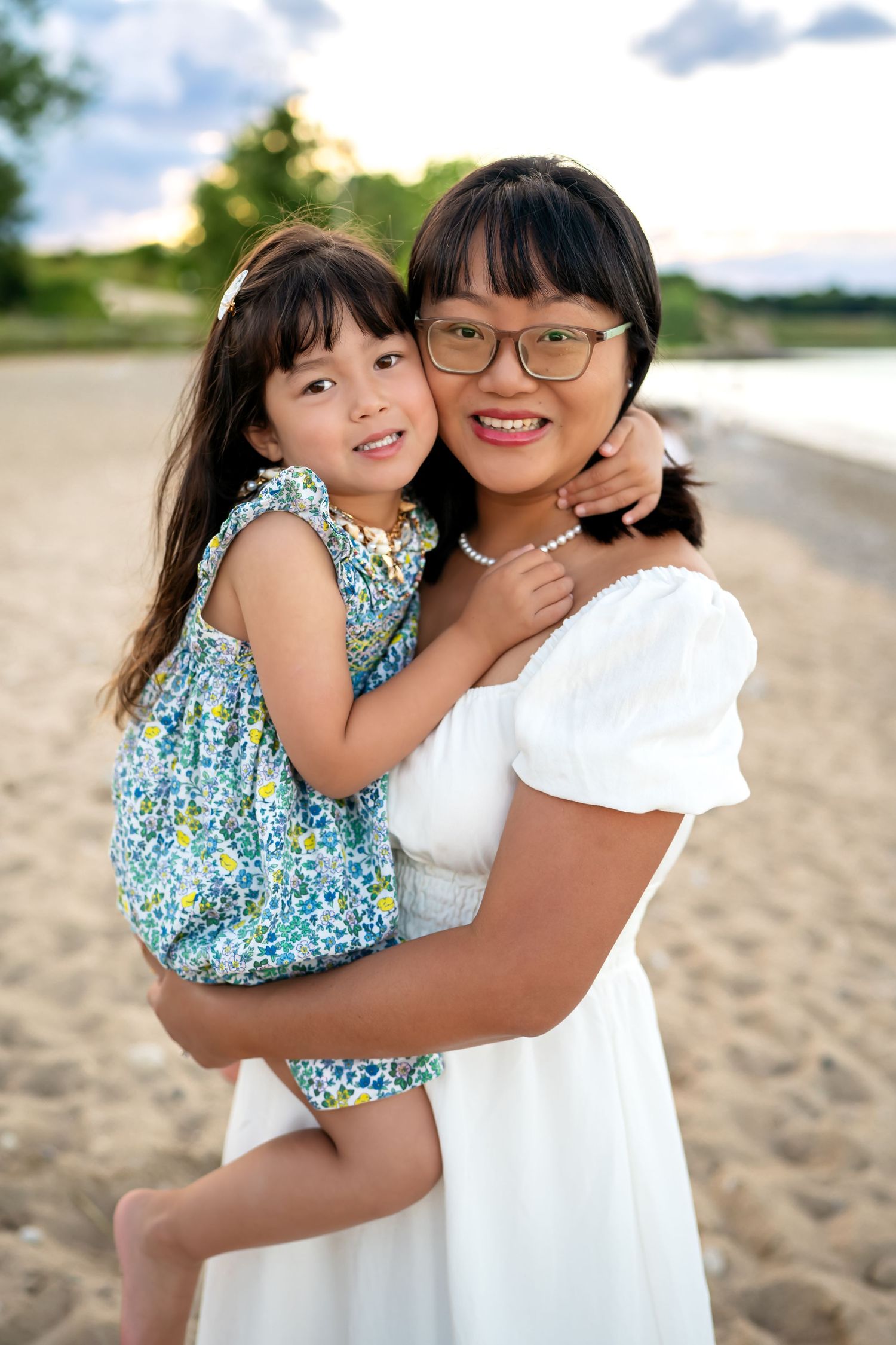 Heartwarming moment captured between two people embracing and sharing joyful moments on a sunny beach.