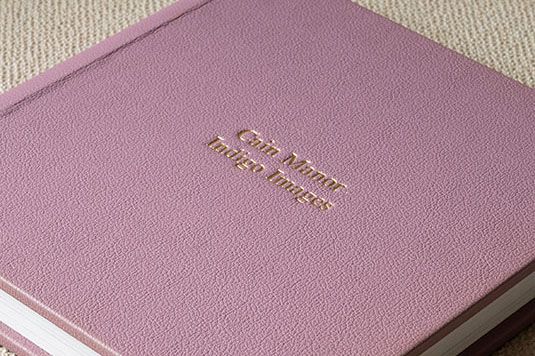 Pink or mauve colored textured book covers shown in a sequence of diagonal overlapping photographs.
