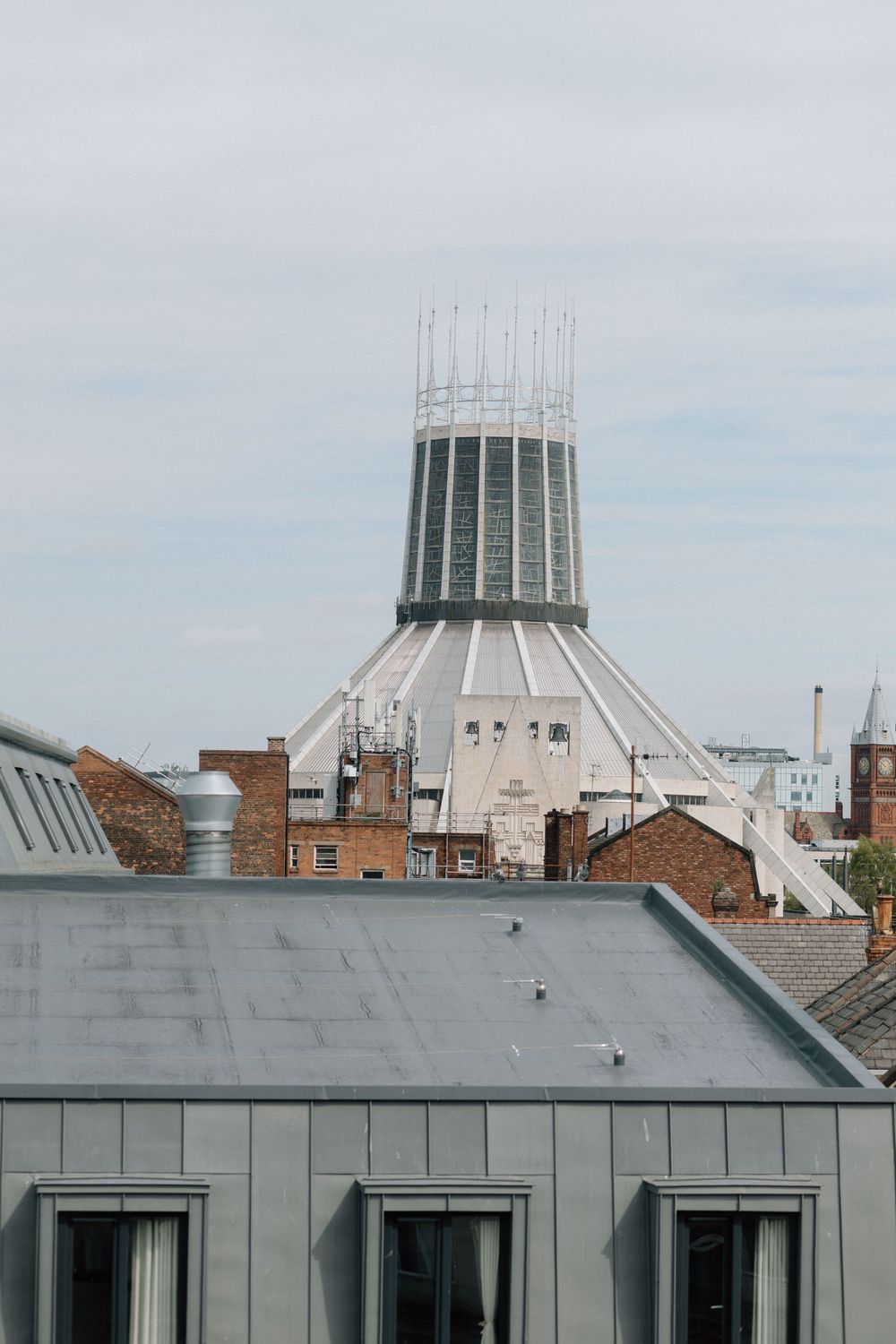 The Liverpool Metropolitan Cathedral's distinctive crown-shaped spire and modern white architecture rises above city rooflines.