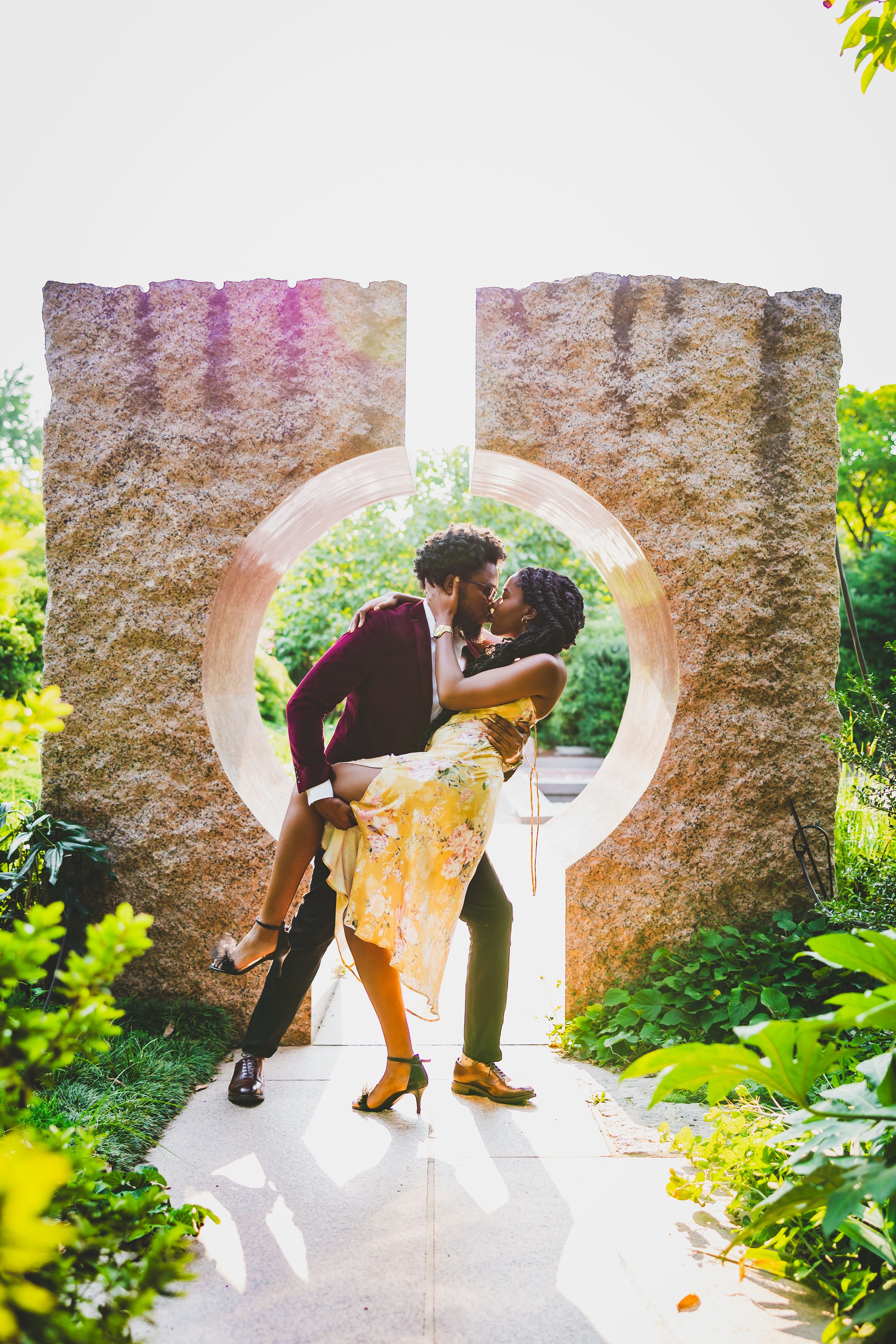 A sequence of romantic silhouettes through an arched stone passageway shows a couple in a playful dance-like pose.