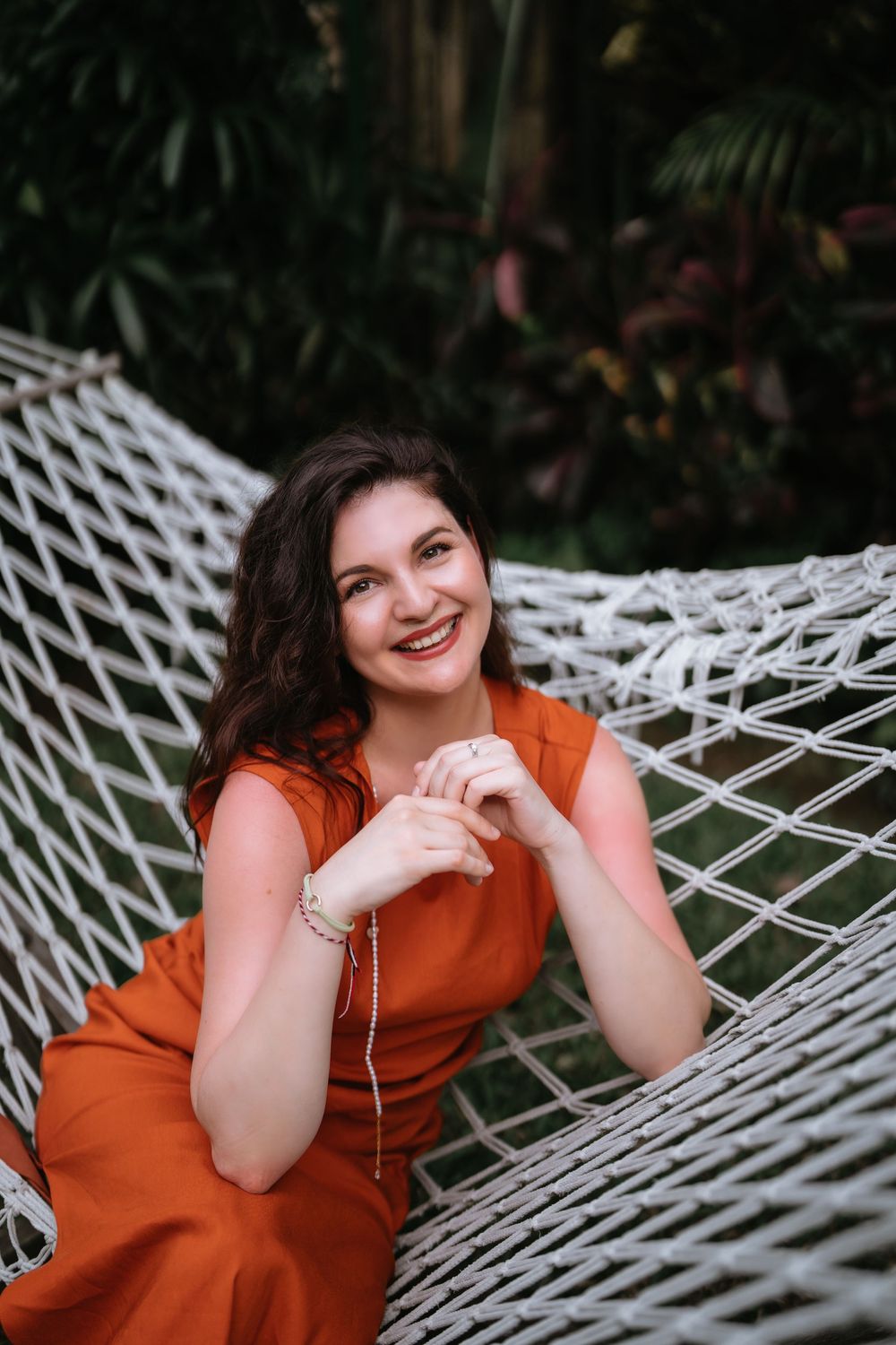 A series of relaxed outdoor portraits on a white hammock in a natural setting.