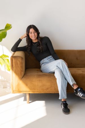 Lifestyle photo on tan velvet couch with natural lighting and minimalist decor.