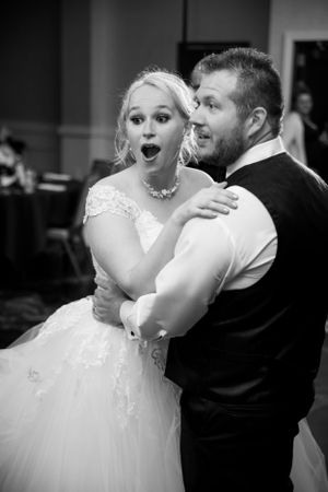 Candid reception moment showing couple's joyful reaction during their wedding celebration.