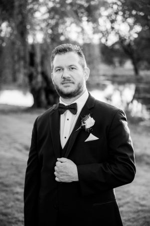 Formal portrait of someone in a black tuxedo and bow tie.